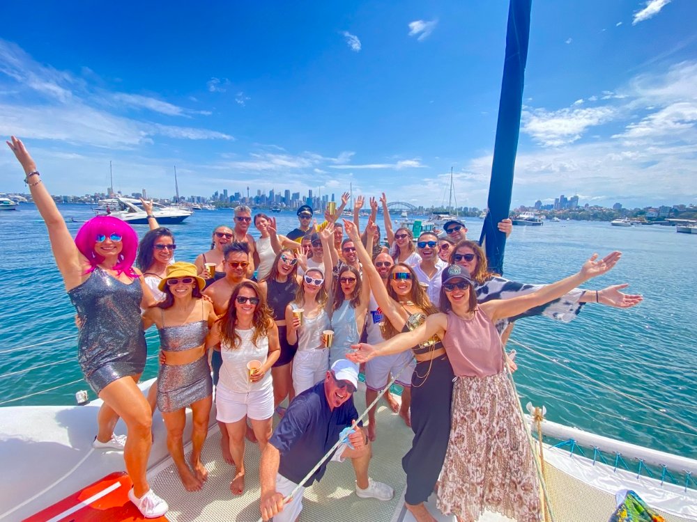 WanderBuddies members meeting new friends on a Sydney Harbour catamaran cruise
